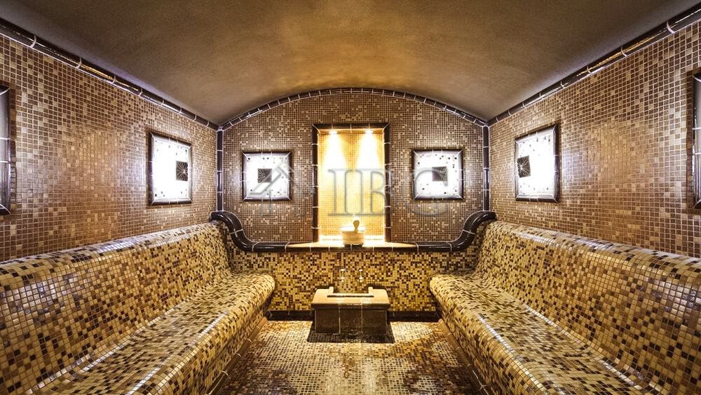 Elegant 1-bedroom apartment with mosaic tiled walls and cozy seating area near Balchik.