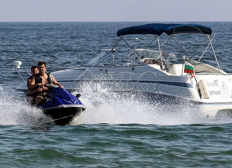 Yacht and jet ski on the sea near Balchik, Bulgaria.