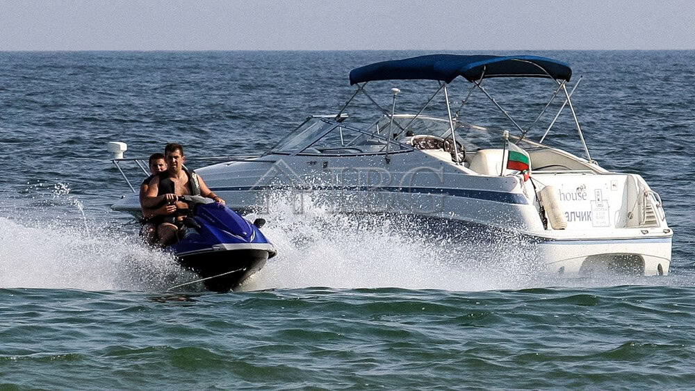 Yacht and jet ski on the sea near Balchik, Bulgaria.