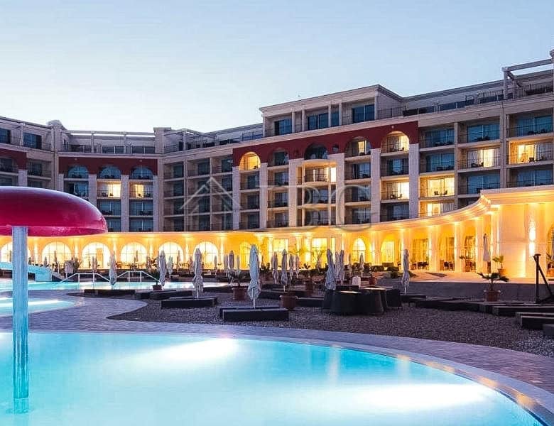 Modern one-bedroom apartment at Lighthouse Golf Resort in Balchik with pool view.