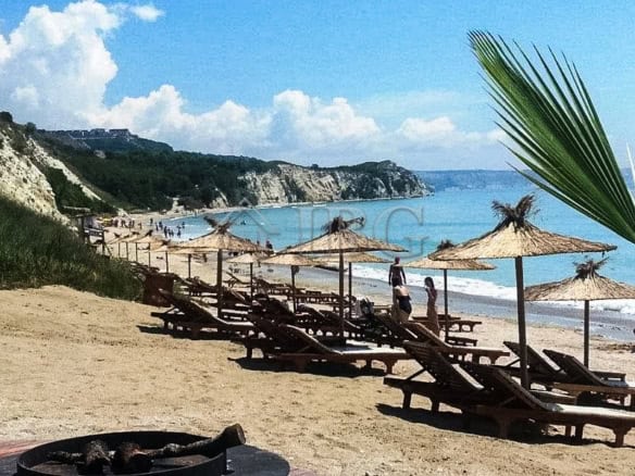 Bright beach scene with sun loungers and umbrellas at Balchik coast.