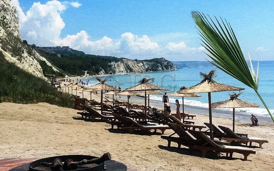 Bright beach scene with sun loungers and umbrellas at Balchik coast.