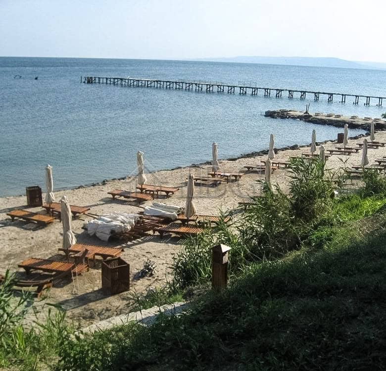 Beach view with sun loungers and umbrellas at Lighthouse Golf & Spa Resort. Perfect for relaxing hol.
