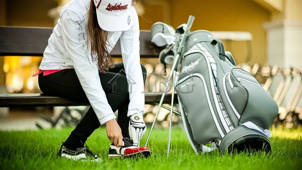 Woman preparing golf clubs outside a golf course, showcasing luxury living.