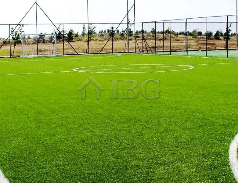 View of a well-maintained football field at Lighthouse Golf & Spa Resort with clear skies.