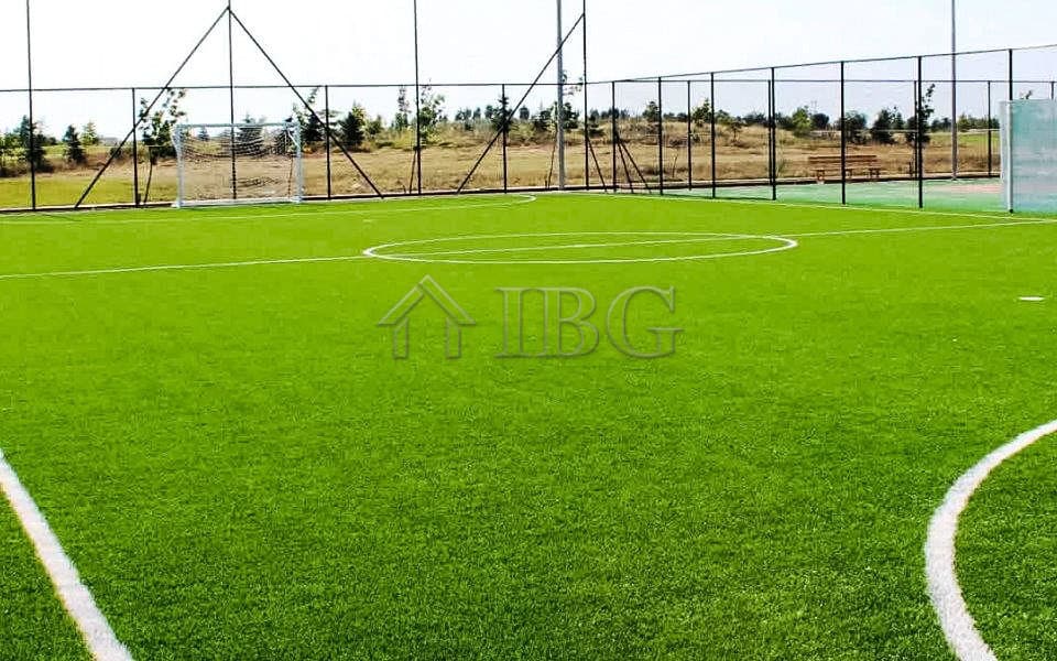 View of a well-maintained football field at Lighthouse Golf & Spa Resort with clear skies.