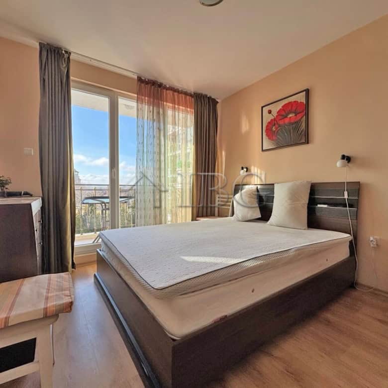 Bright bedroom with balcony overlooking pool at Messembria Palace, Sunny Beach.