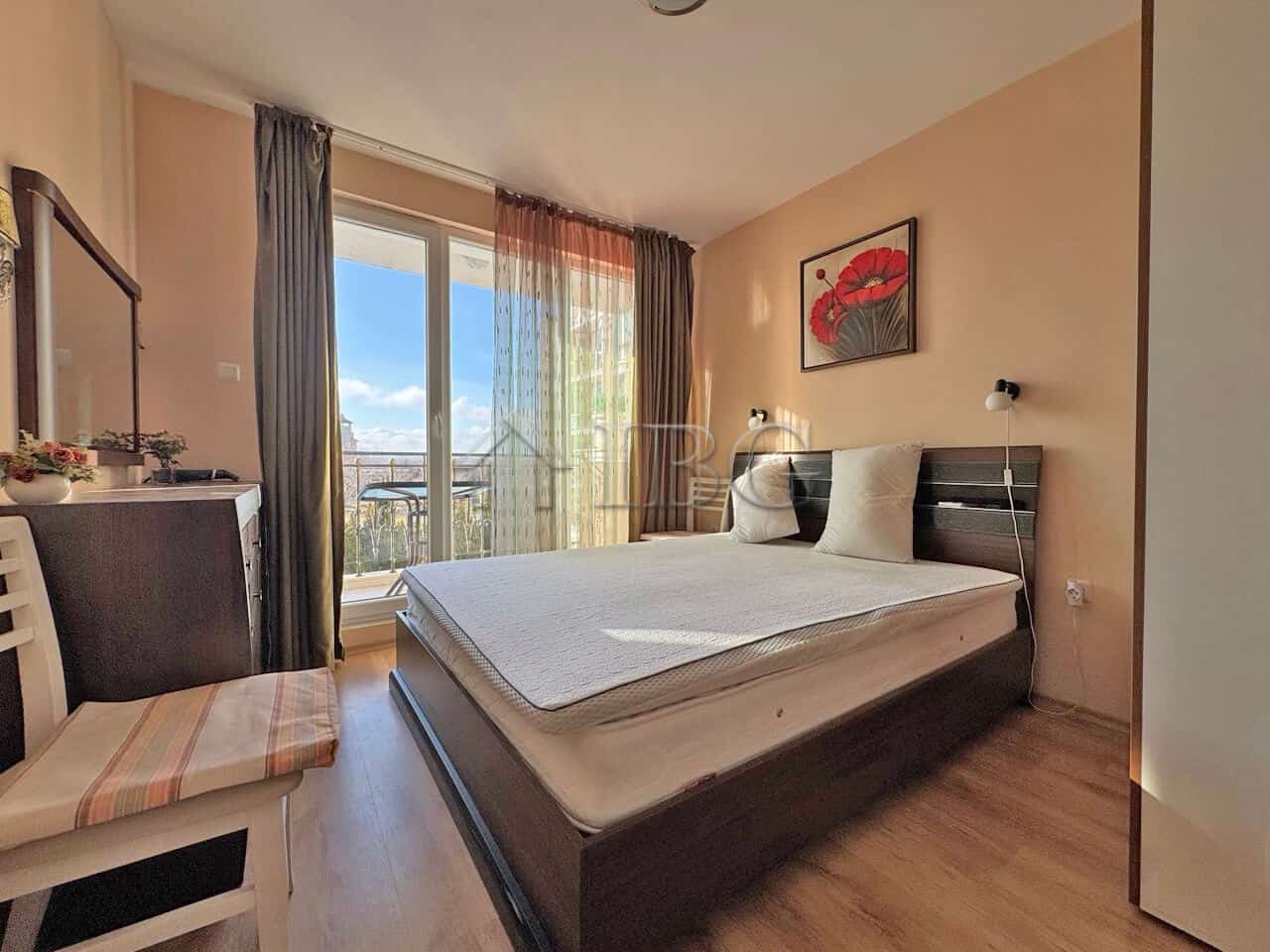 Bright bedroom with balcony overlooking pool at Messembria Palace, Sunny Beach.