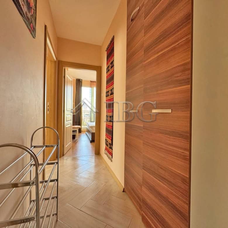 Bright hallway in Messembria Palace with wooden wall panels and access to living area.