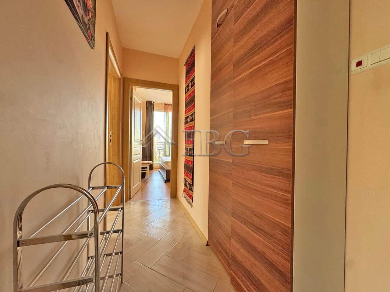 Bright hallway in Messembria Palace with wooden wall panels and access to living area.