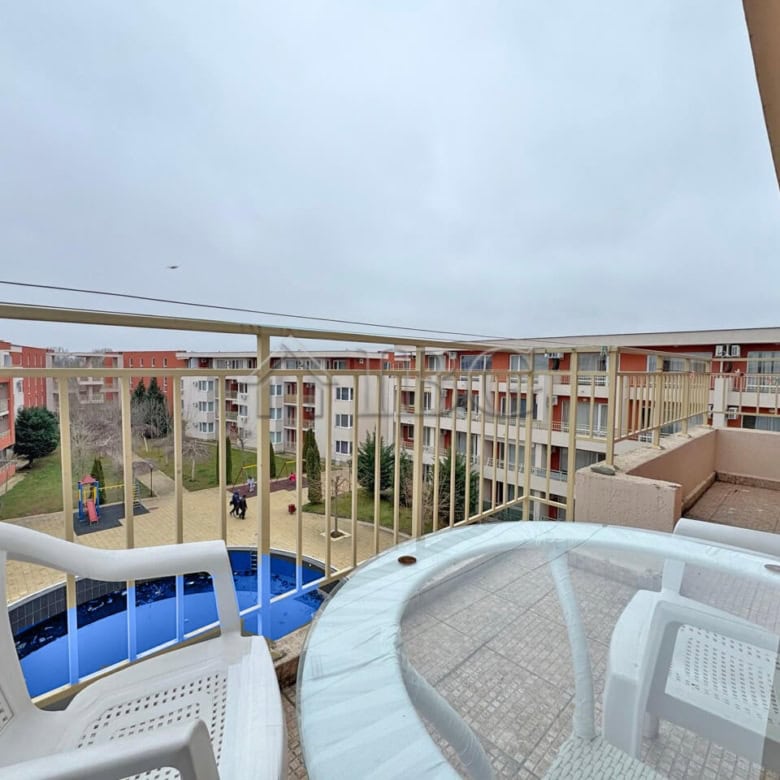 Bright view of the pool from a balcony in a 1-bedroom apartment at Nessebar Fort Club, Sunny Beach.