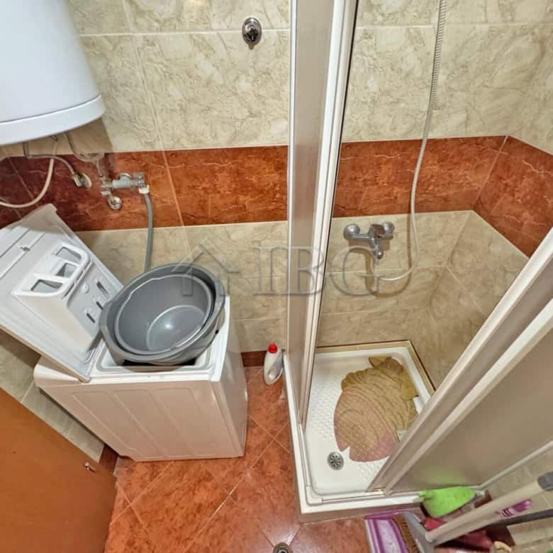 Compact bathroom with washing machine and shower in Nessebar Fort Club, Sunny Beach.
