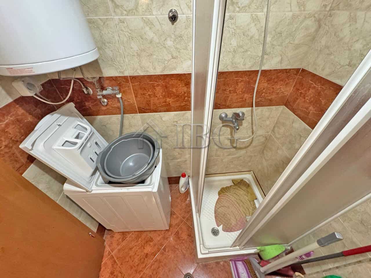 Compact bathroom with washing machine and shower in Nessebar Fort Club, Sunny Beach.