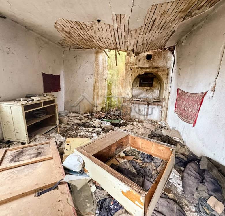 Abandoned room with damaged walls and ceiling, showcasing a potential renovation near the sea. Large.