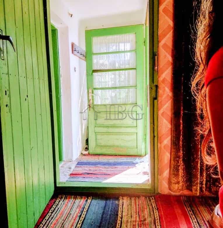 Cozy entrance of a house in a picturesque village close to the Danube River, featuring vibrant green.