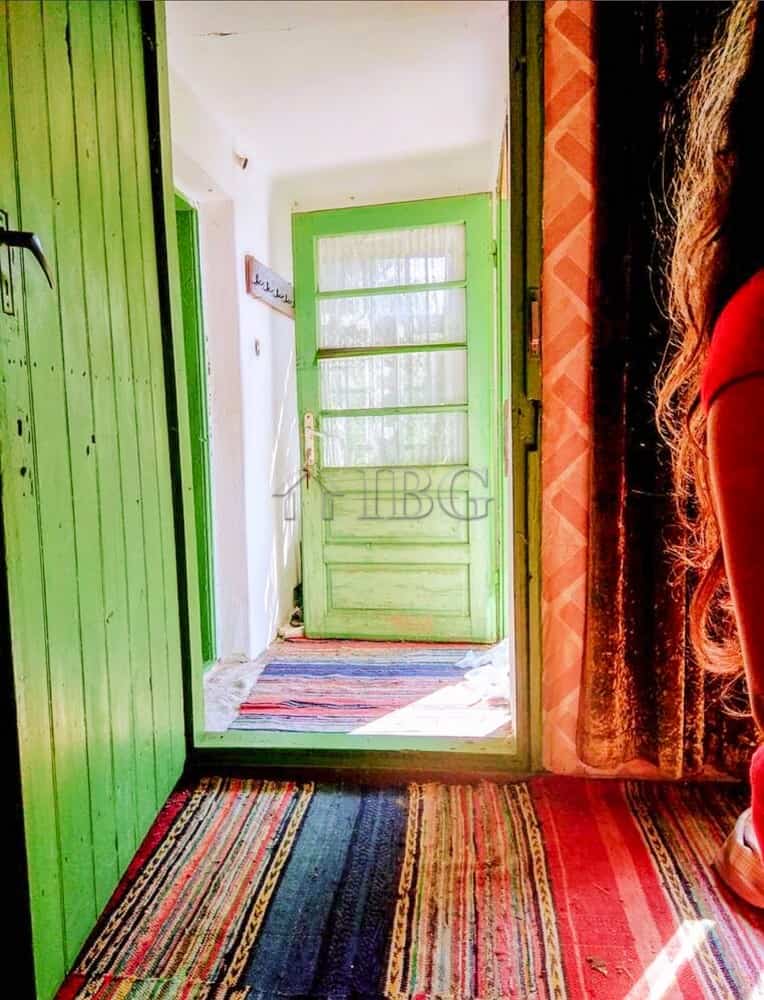 Cozy entrance of a house in a picturesque village close to the Danube River, featuring vibrant green.