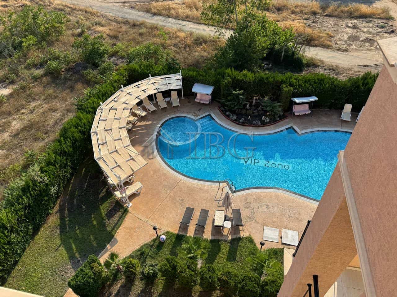 Pool view of a maisonette apartment in Sunny Beach, Bulgaria, with a private pool and surrounding lo.