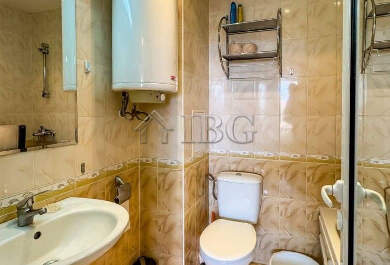 Bathroom with sink, toilet, and water heater in Sveti Vlas apartment.