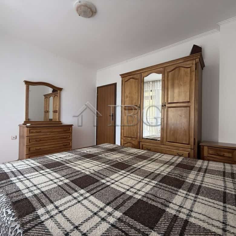 Comfortable bedroom with wooden furniture and ample storage space in Nessebar.