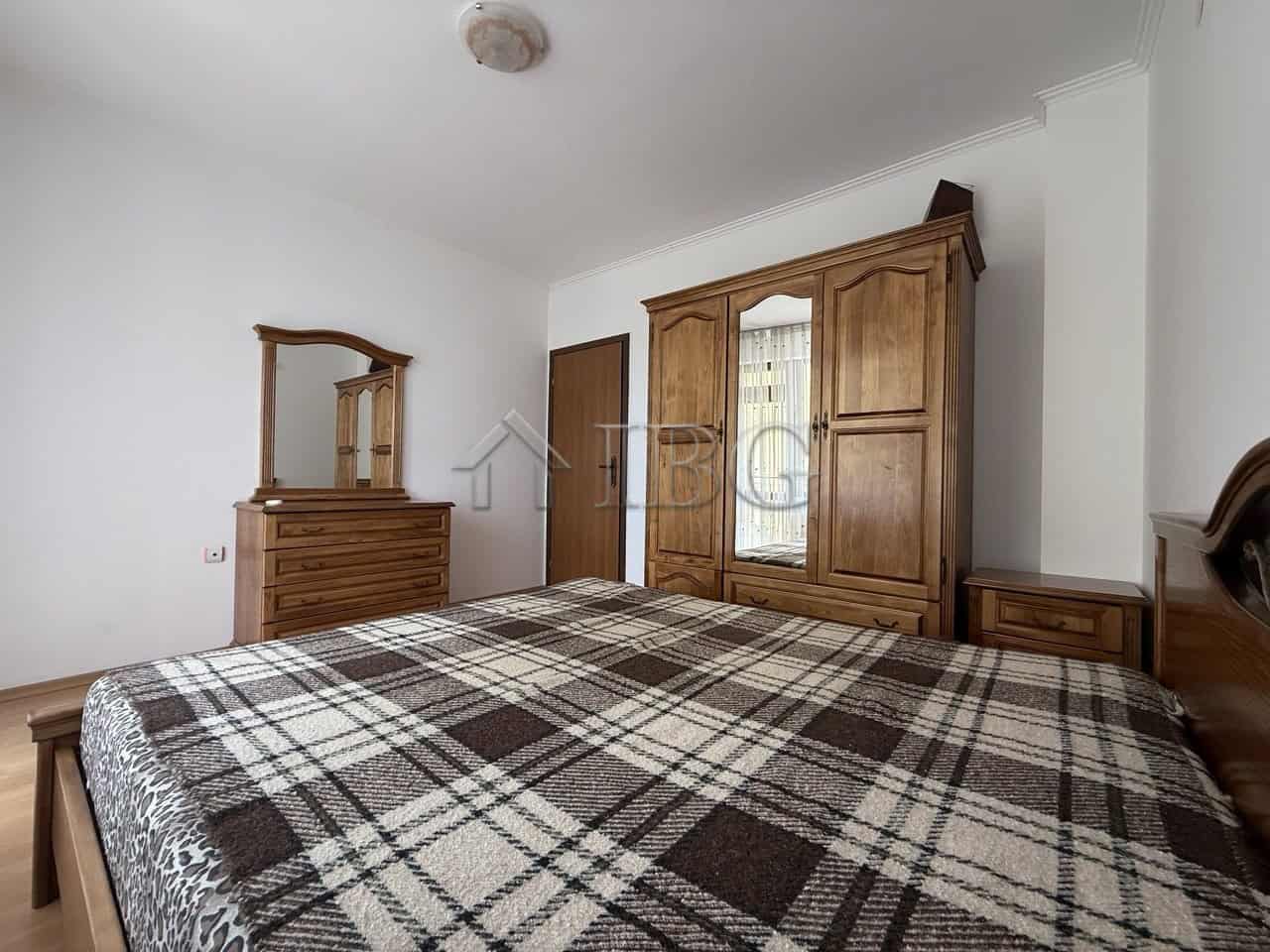 Comfortable bedroom with wooden furniture and ample storage space in Nessebar.