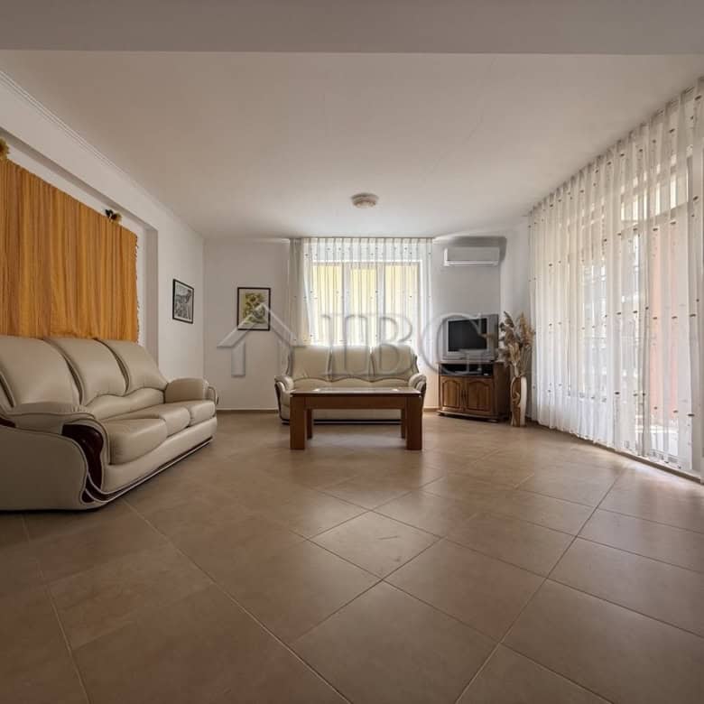 Bright living room with large windows and elegant furnishings in Tili Complex, Aurelia District, Nes.