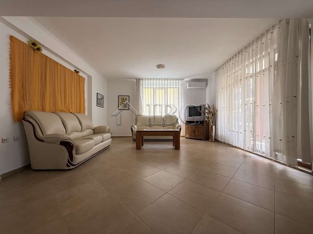 Bright living room with large windows and elegant furnishings in Tili Complex, Aurelia District, Nes.