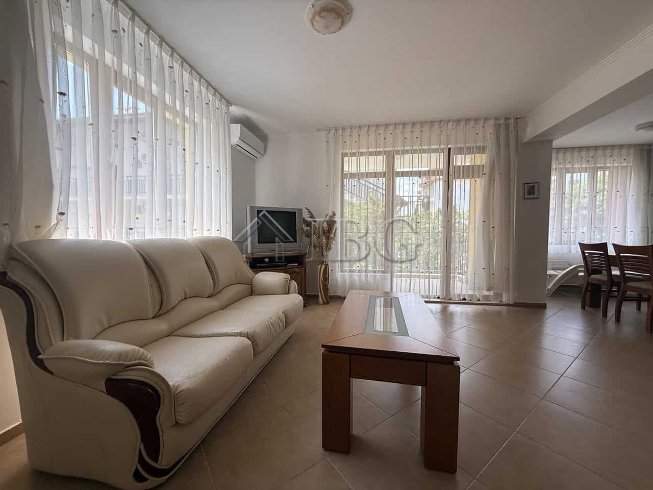 Bright living room with large windows and sheer curtains in Tili Complex, Aurelia District, Nessebar.