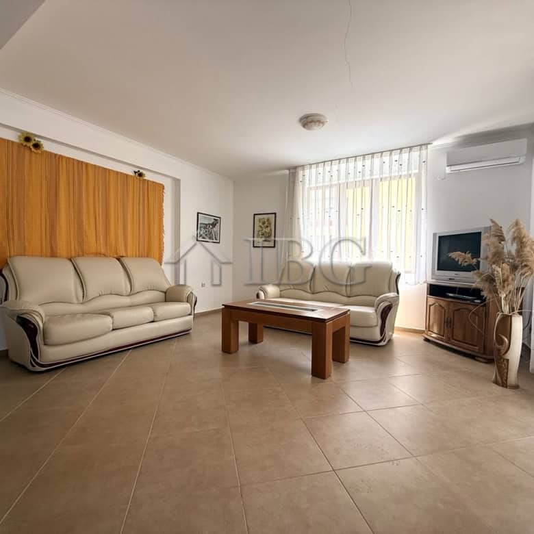 Bright living room with large windows and modern furnishings in Tili Complex, Aurelia District, Ness.