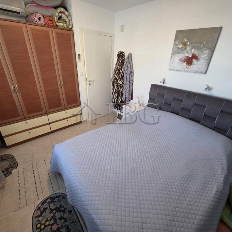 Spacious bedroom with modern decor, wardrobe, and natural light in Ravda Sun & Sea Resort.