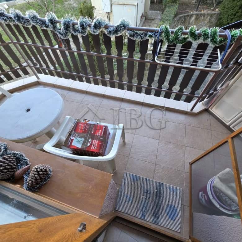 Balcony view of a 2-bedroom apartment in Ravda Sun & Sea Resort, featuring outdoor seating and decor.