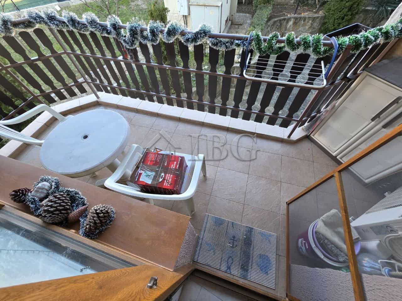Balcony view of a 2-bedroom apartment in Ravda Sun & Sea Resort, featuring outdoor seating and decor.
