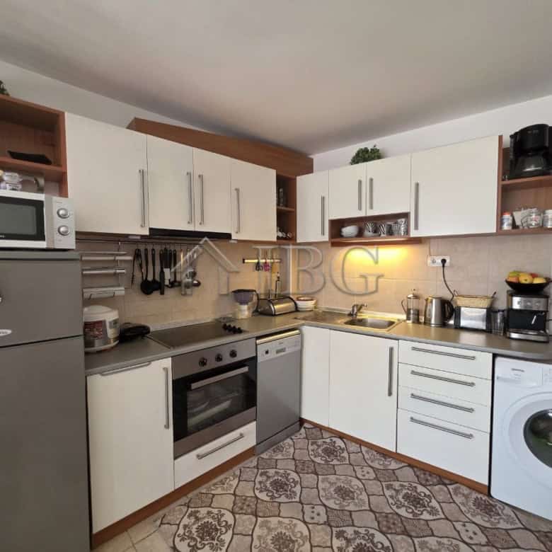 Bright, fully equipped kitchen with white cabinets and stainless steel appliances in Ravda resort.