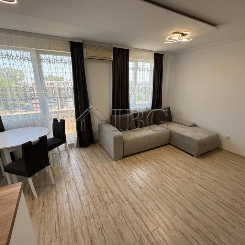 Bright living room with large windows and modern furniture.