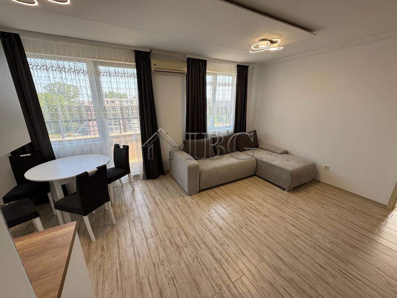 Bright living room with large windows and modern furniture.