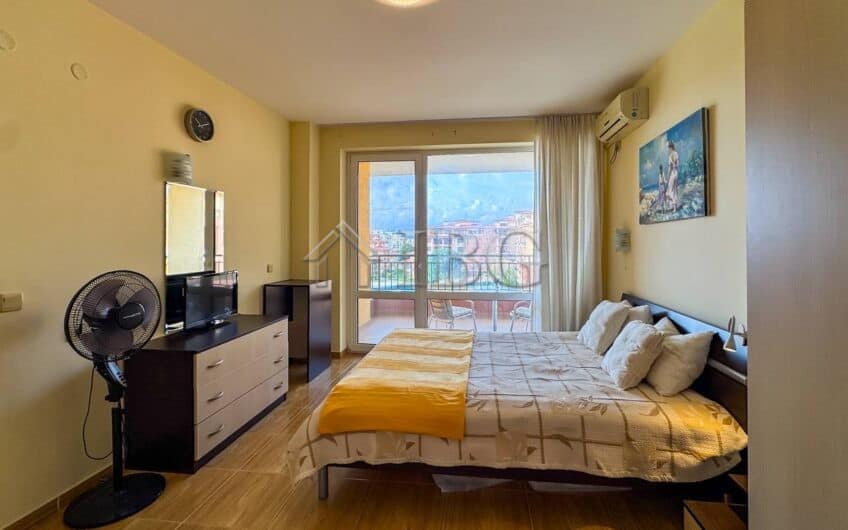 Bright bedroom with balcony view near the beach.
