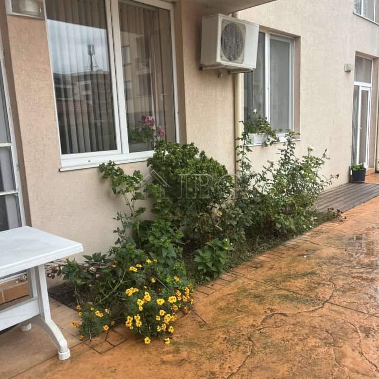 Outdoor view of a 1-bedroom apartment in Balkan Breeze 2, Sunny Beach, featuring a small garden and.
