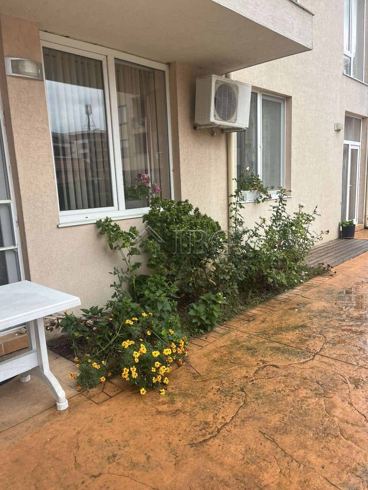 Outdoor view of a 1-bedroom apartment in Balkan Breeze 2, Sunny Beach, featuring a small garden and.
