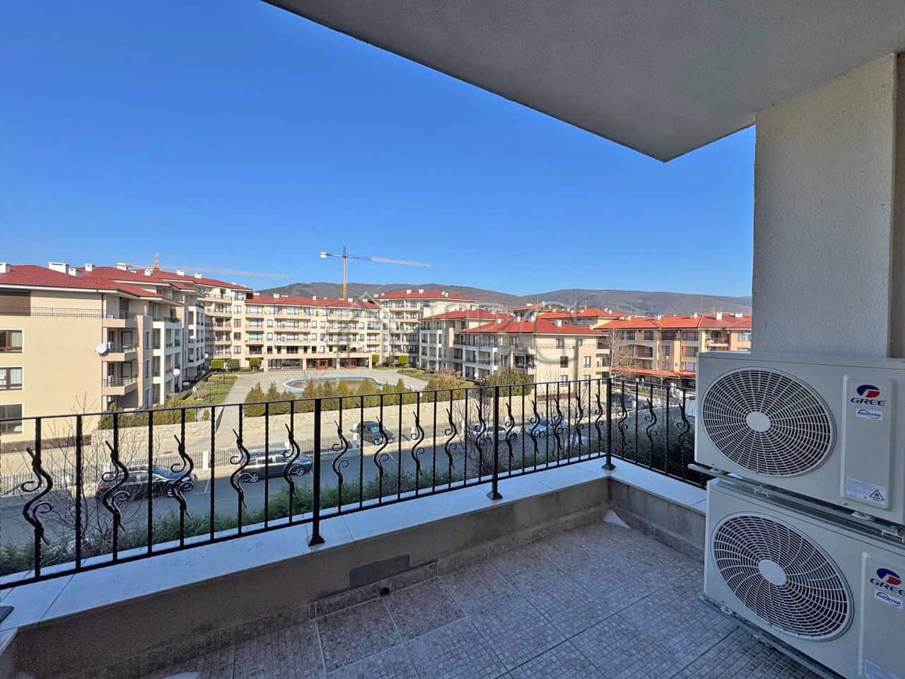 Apartment (1+1) for Sale | Premier Fort Beach, Sveti Vlas – First Line Balcony view of modern residential buildings and blue sky in Sveti Vlas.