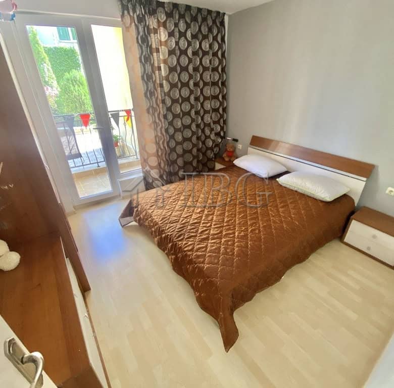 Bright bedroom with double bed and modern decor in Sveti Vlas apartment.