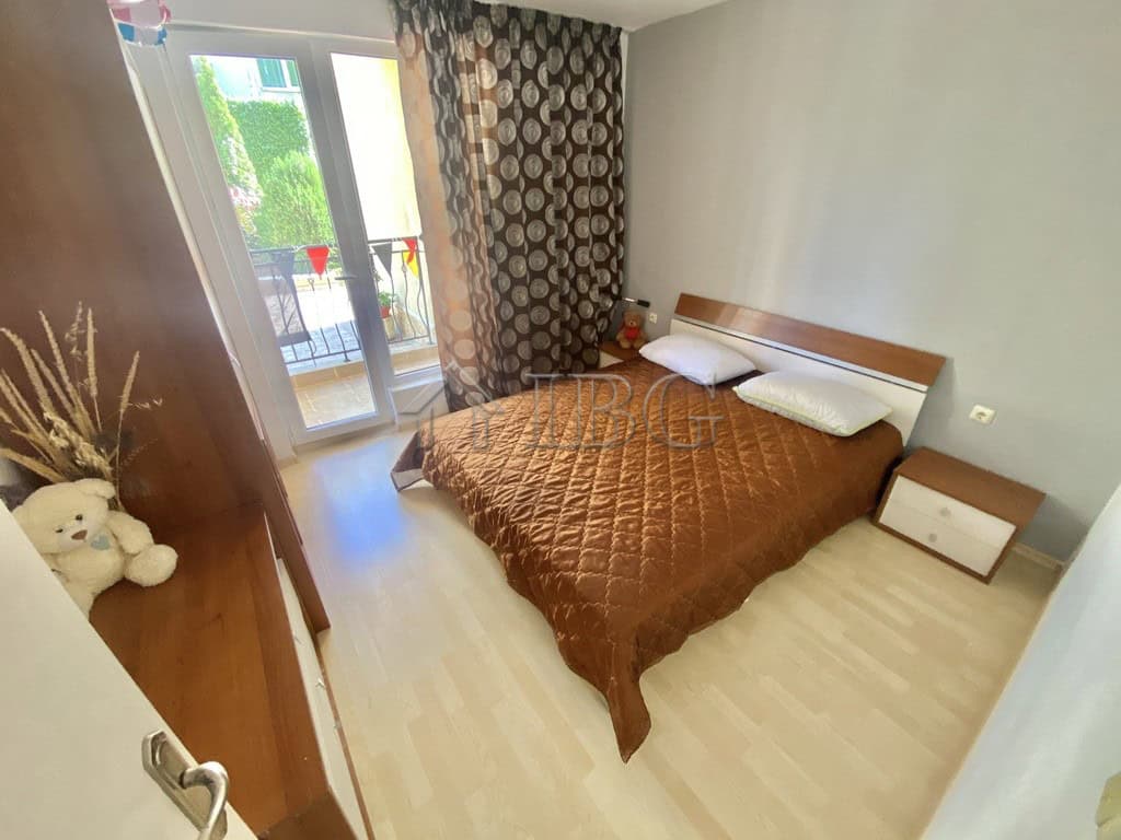 Bright bedroom with double bed and modern decor in Sveti Vlas apartment.