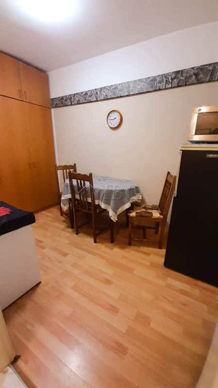 Small dining area with table and chairs in Drujba 2 apartment, Ruse city.
