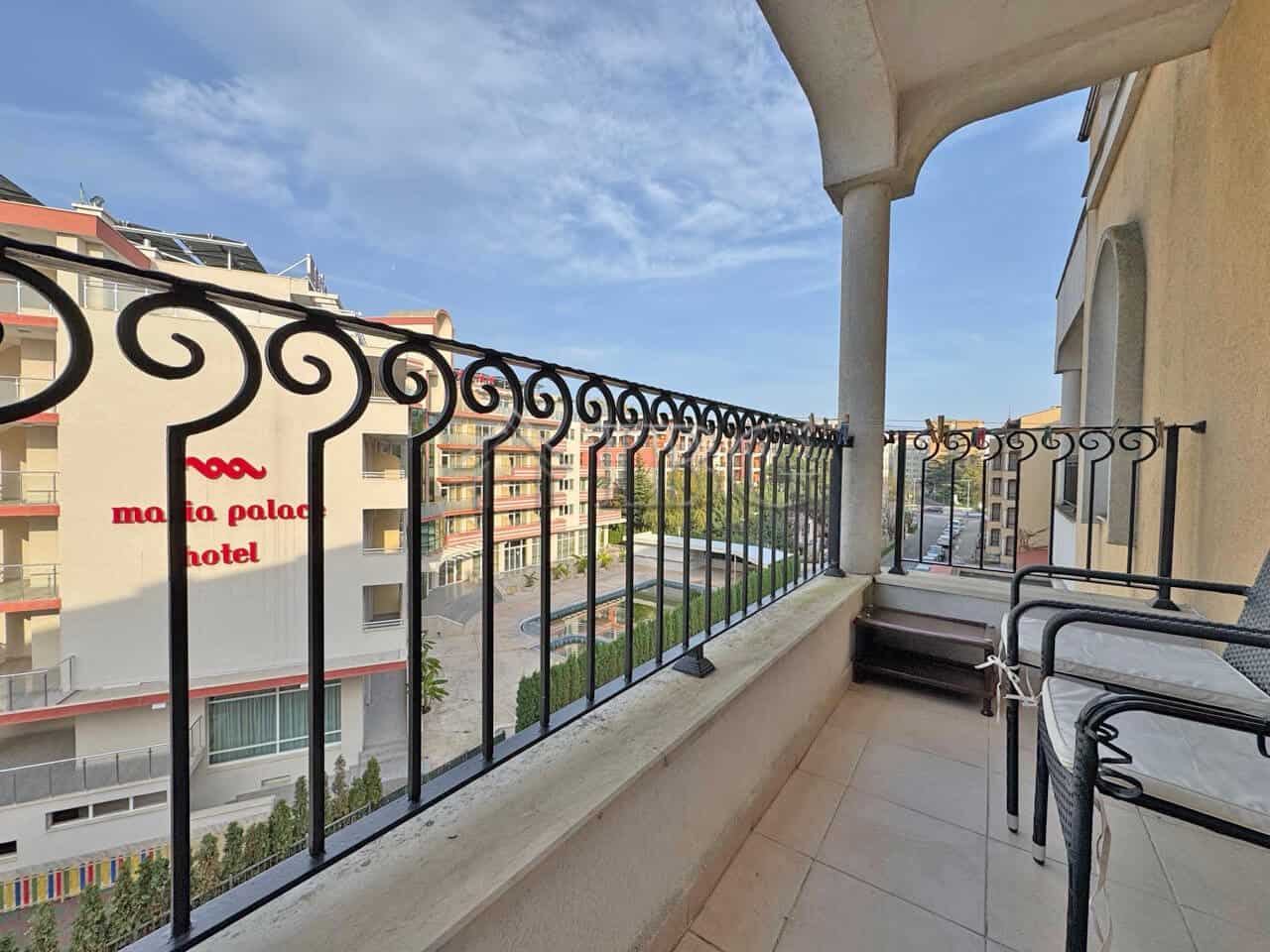 Balcony of a 1-bedroom apartment overlooking Sunny Beach and surrounding buildings.
