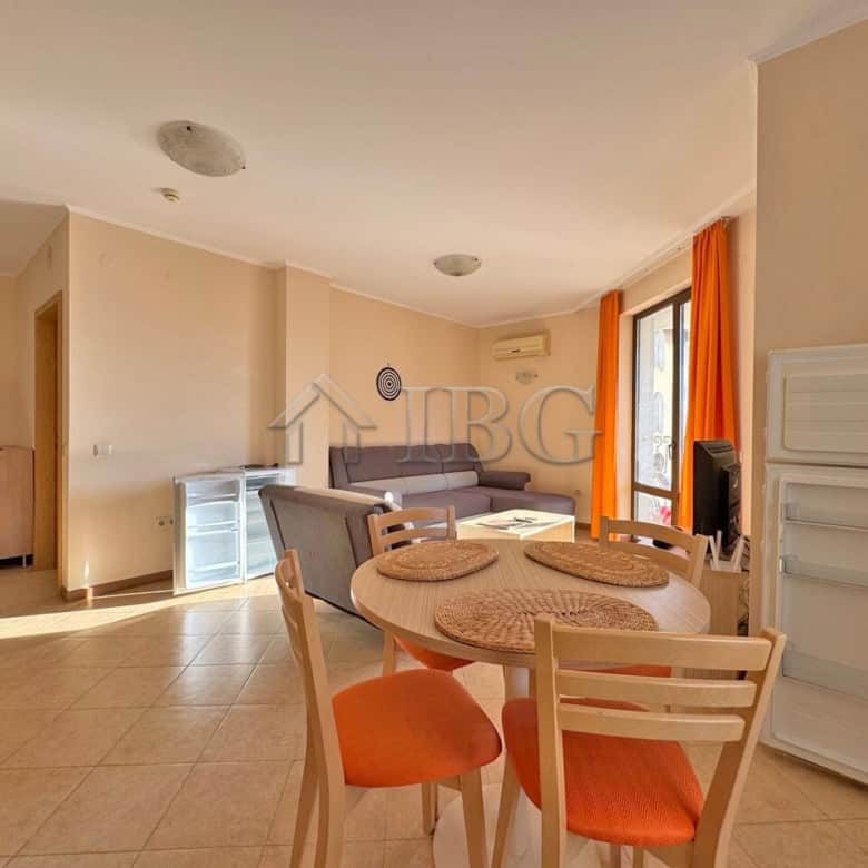 Bright living room with dining area and balcony view.