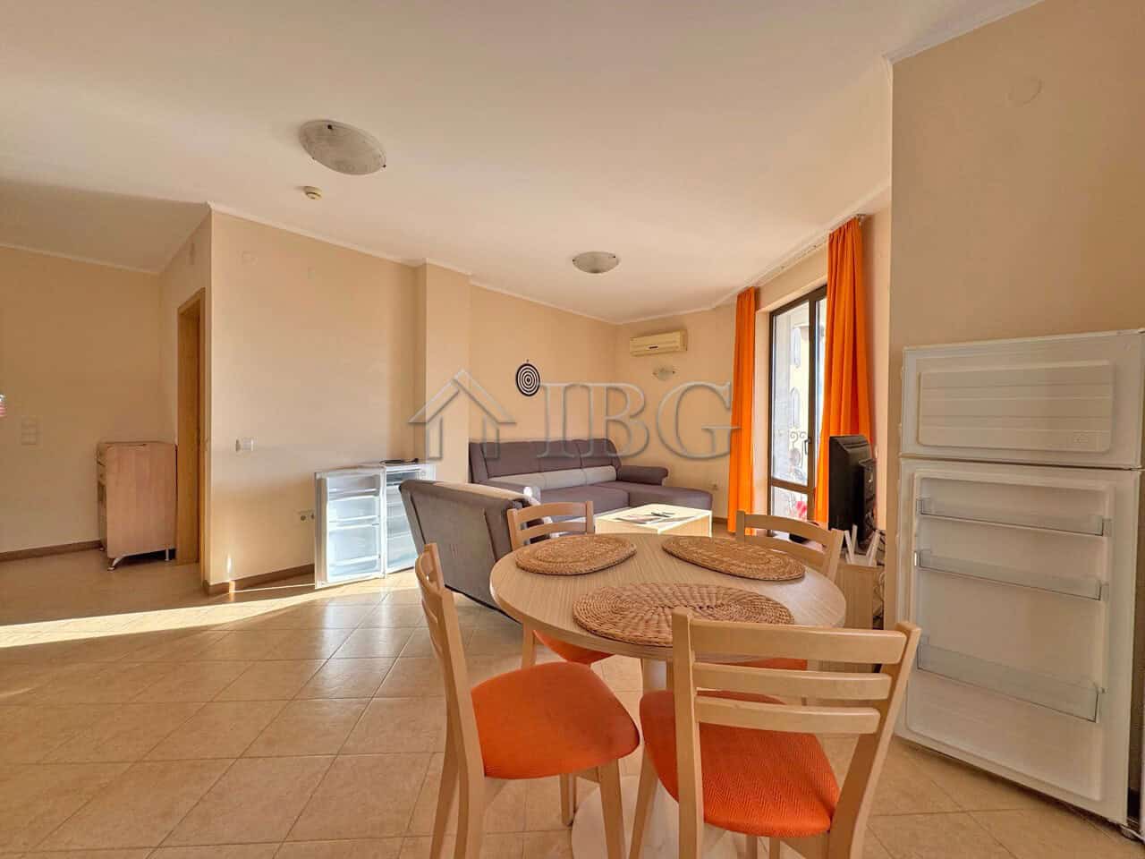 Bright living room with dining area and balcony view.
