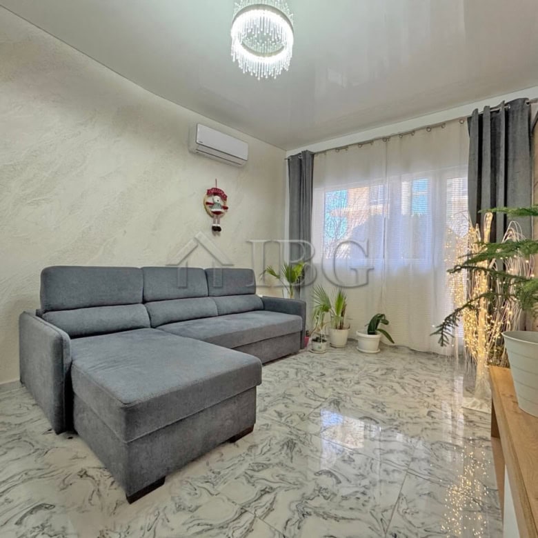 Bright living room with modern decor and large windows in Sunny Beach.