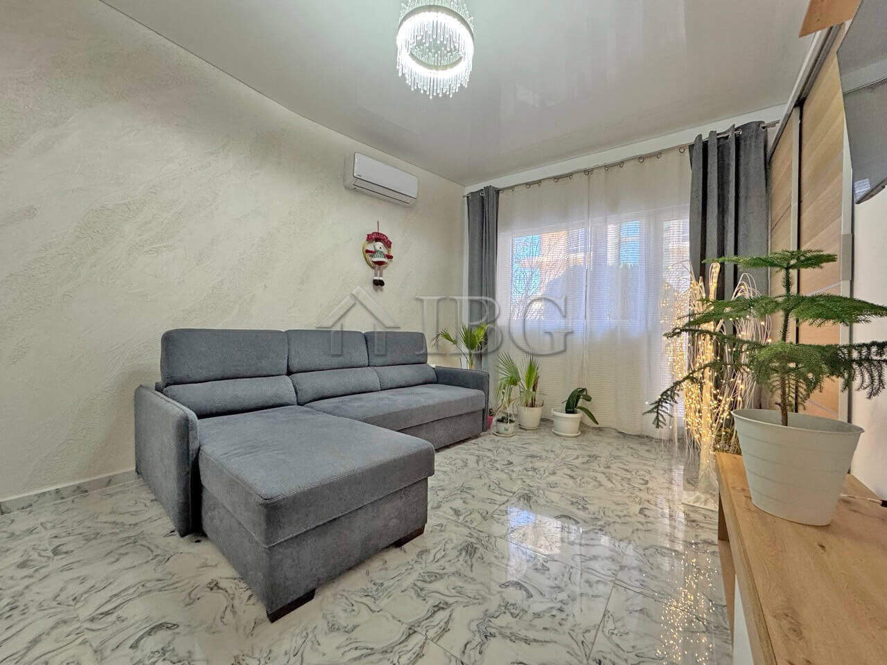 Bright living room with modern decor and large windows in Sunny Beach.