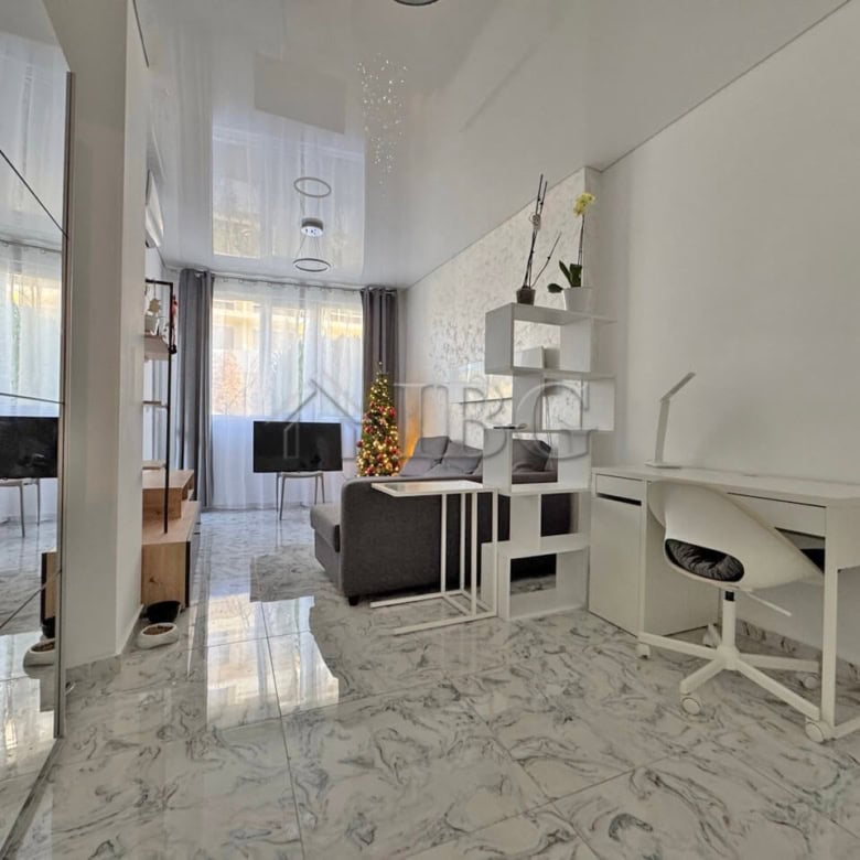 Bright living room with large windows and terrace access, perfect for relaxing and entertaining.