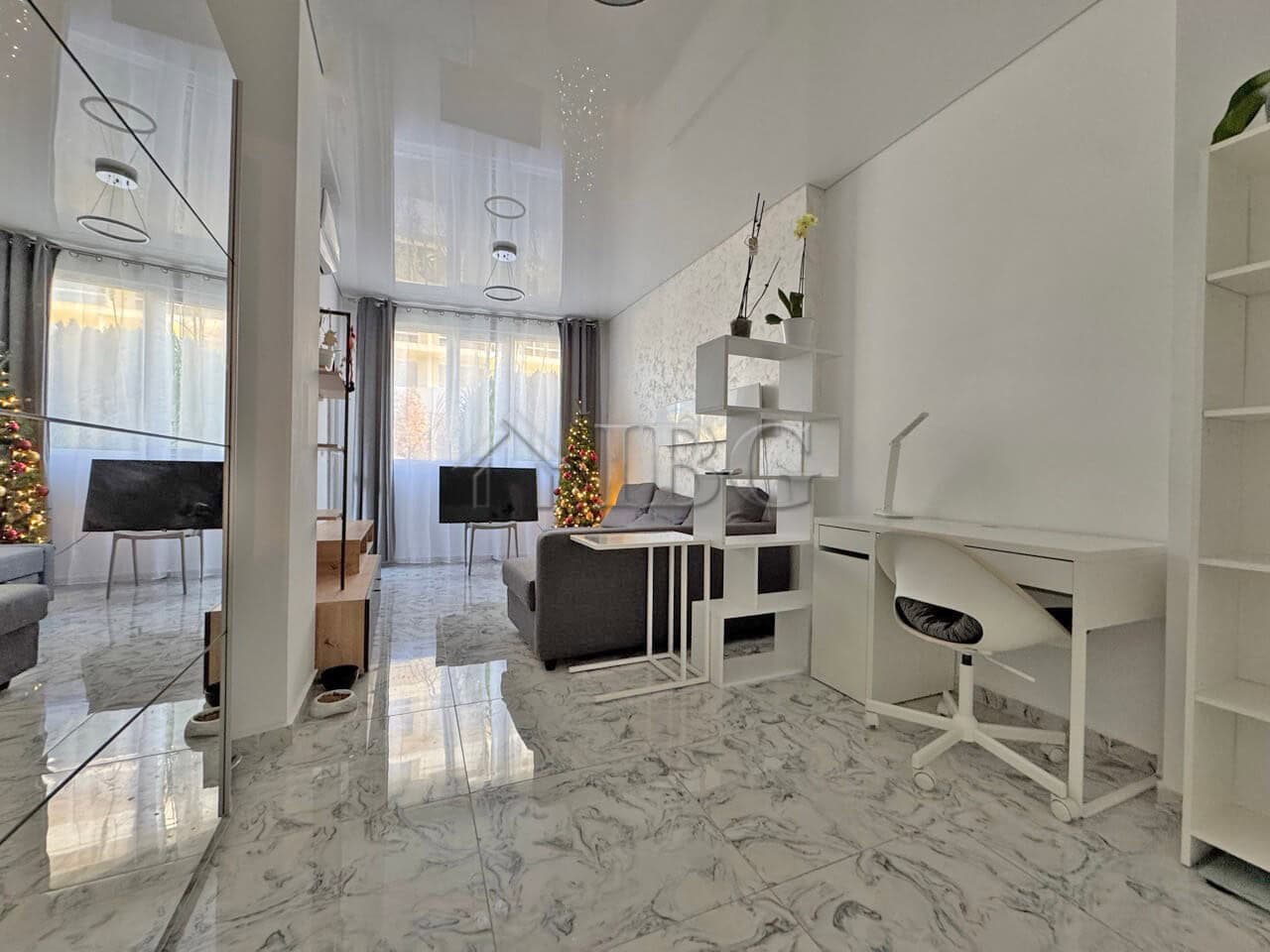 Bright living room with large windows and terrace access, perfect for relaxing and entertaining.