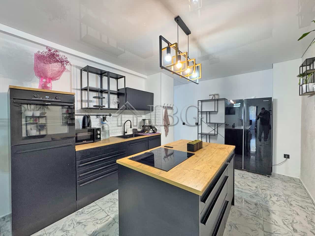 Modern three-room apartment with large terrace in Sunny Beach. Stylish kitchen, contemporary decor,.