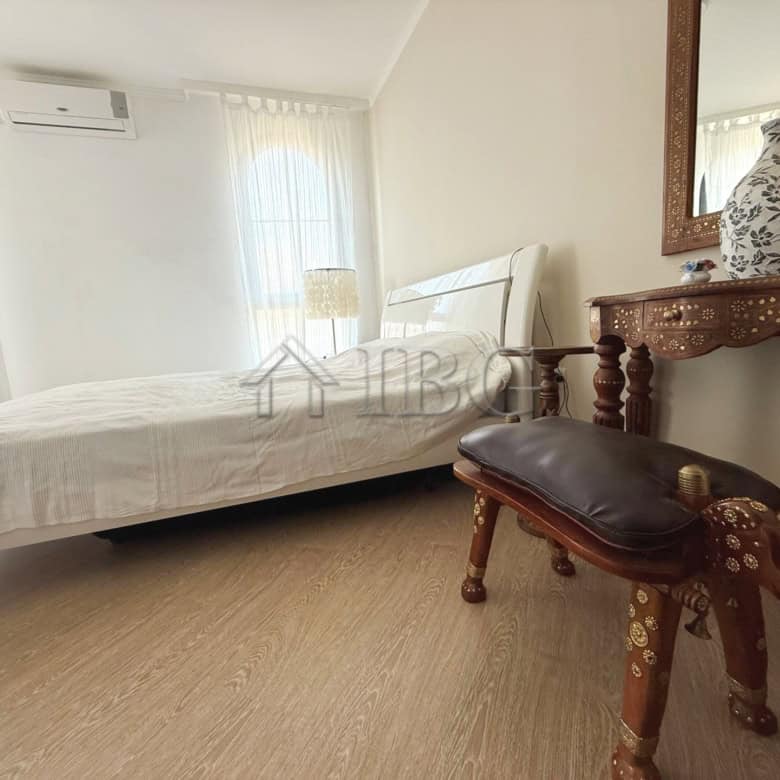 Bedroom with large terrace, bright window, and elegant furniture in Sveti Vlas apartment.